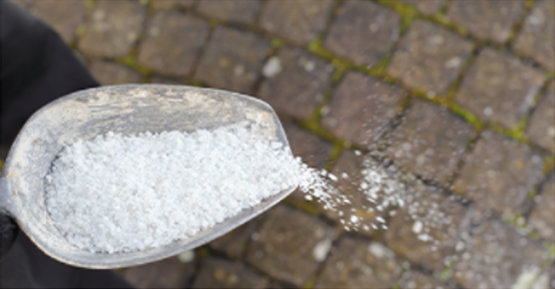 Salt being poured on driveway